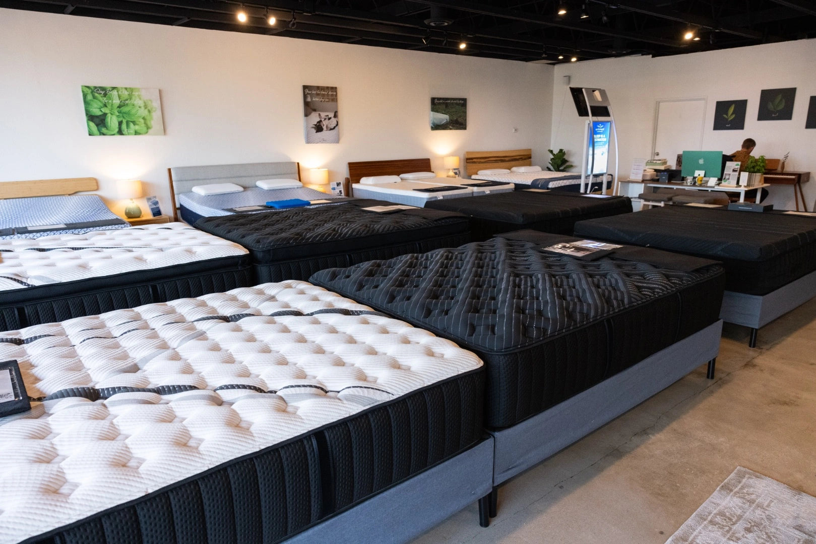 Mattress display in a showroom with various mattress options.