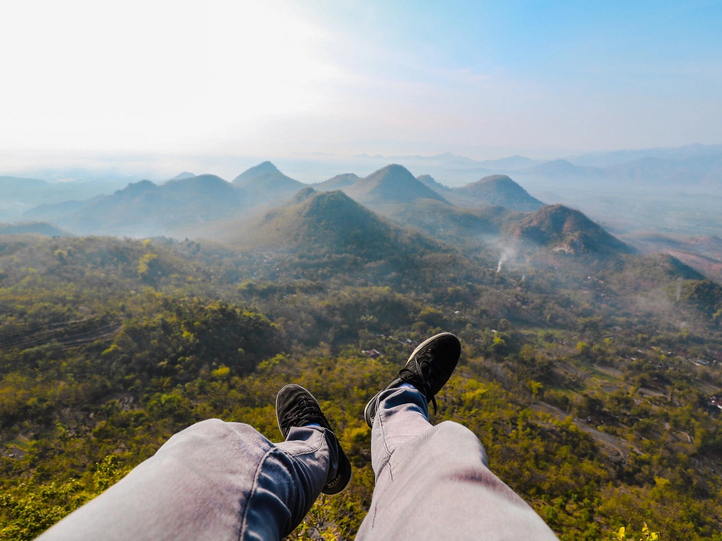 Person sitting on a mountain edge